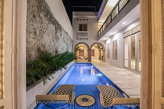Pool in the patio of a colonial house at night